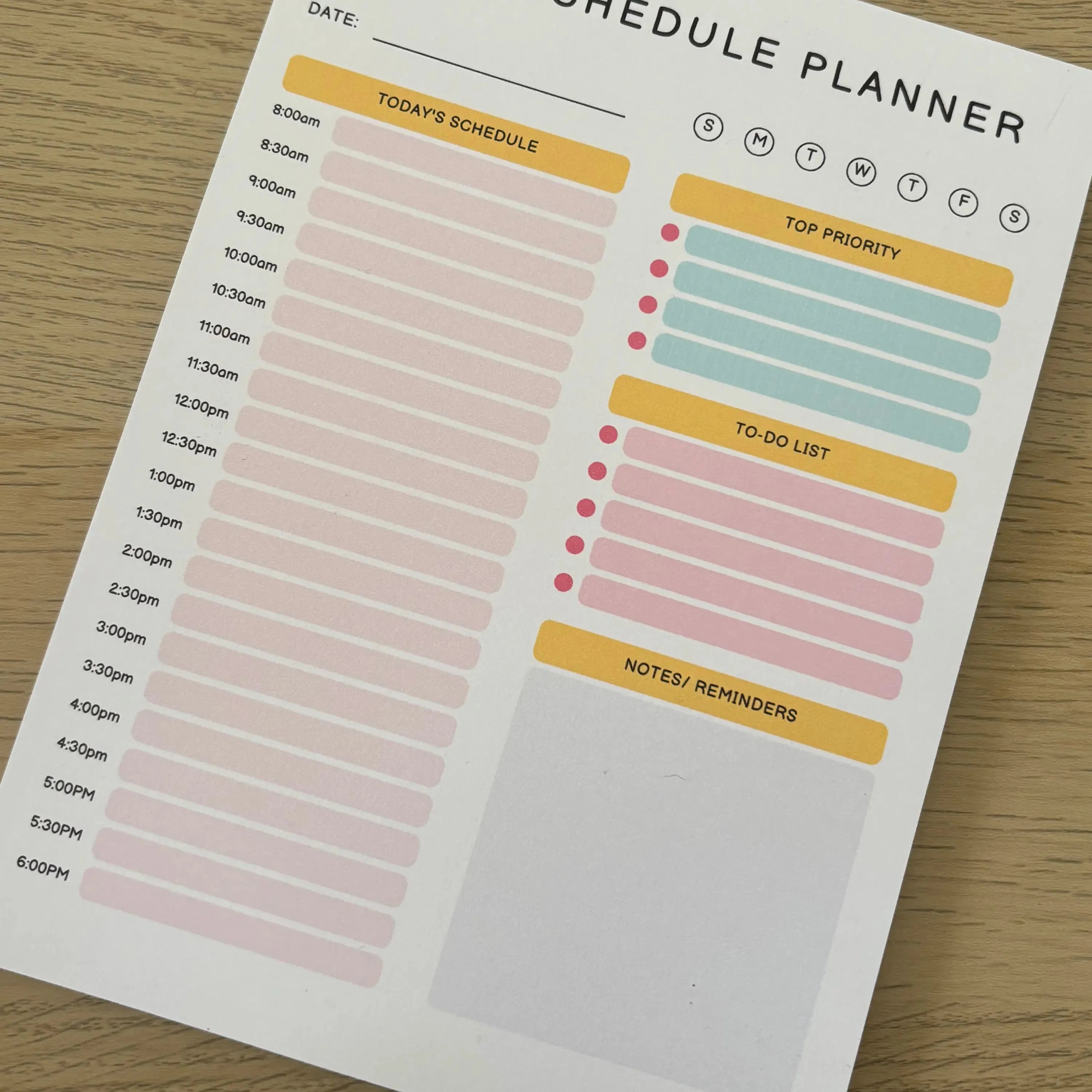 Daily Schedule Planner notepad with time slots, task priority, to-do list, and notes sections in pastel colors.
