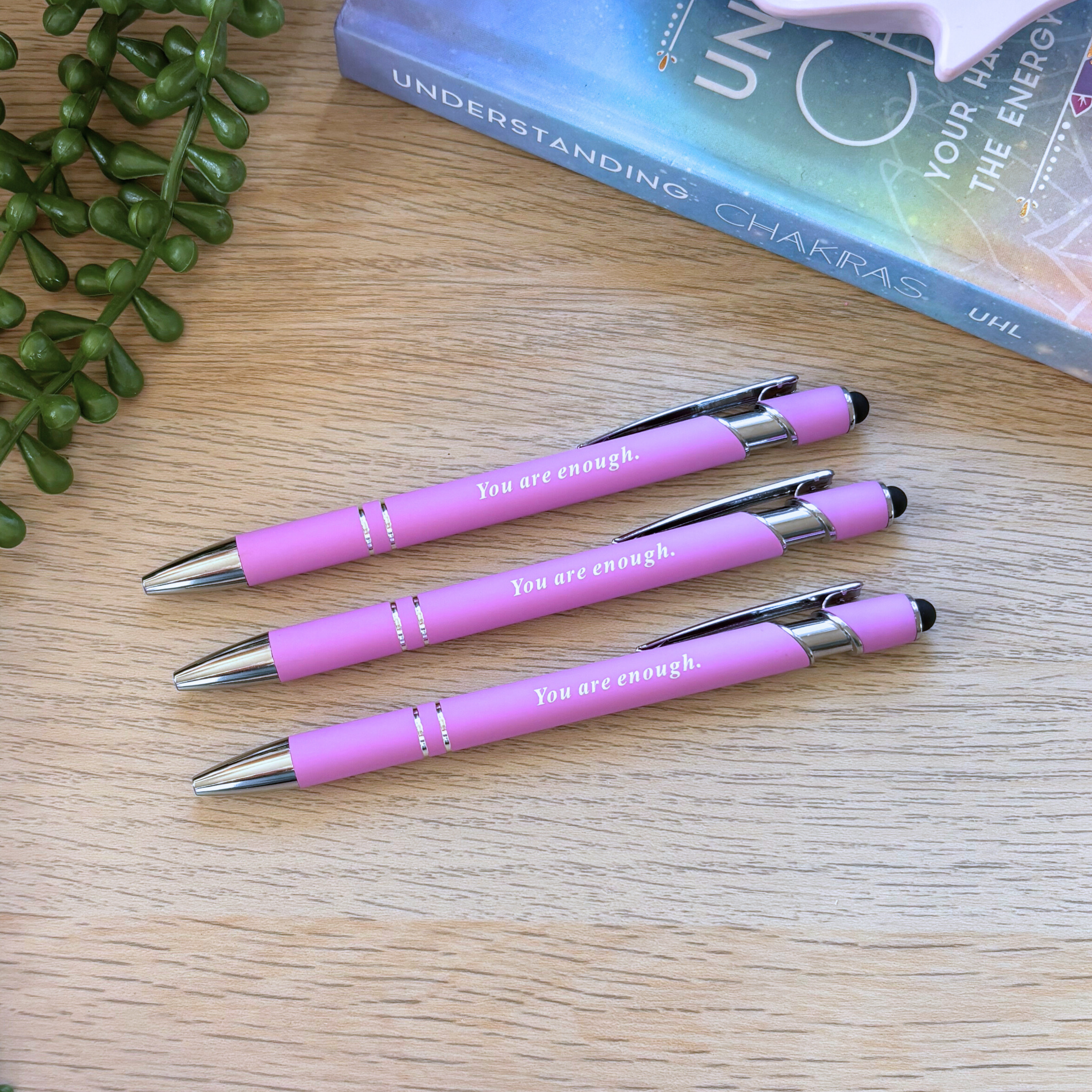 Set of three pink retractable pens with silver clips, each printed with "You are enough" in white text.