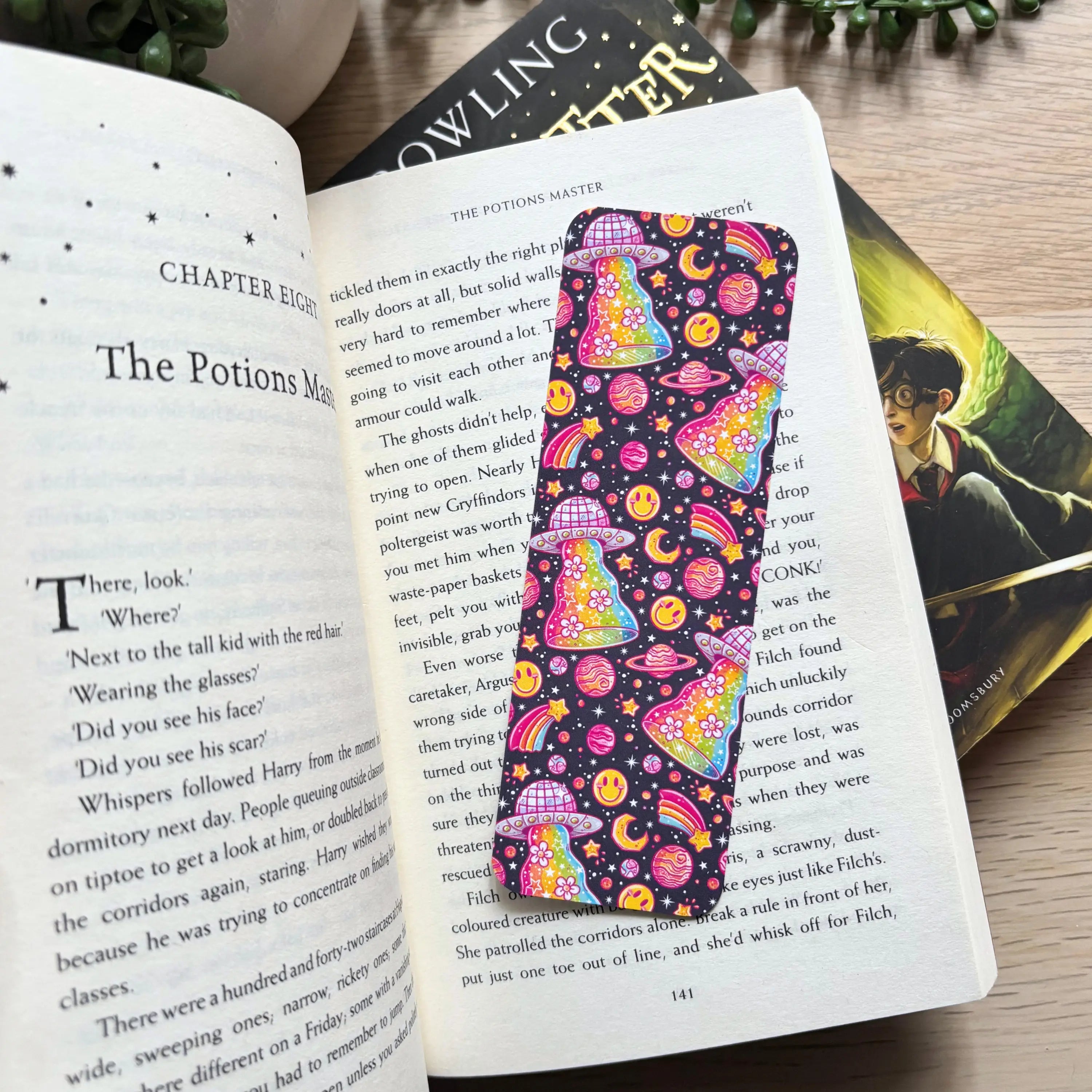 Colorful UFO bookmark on open book page.