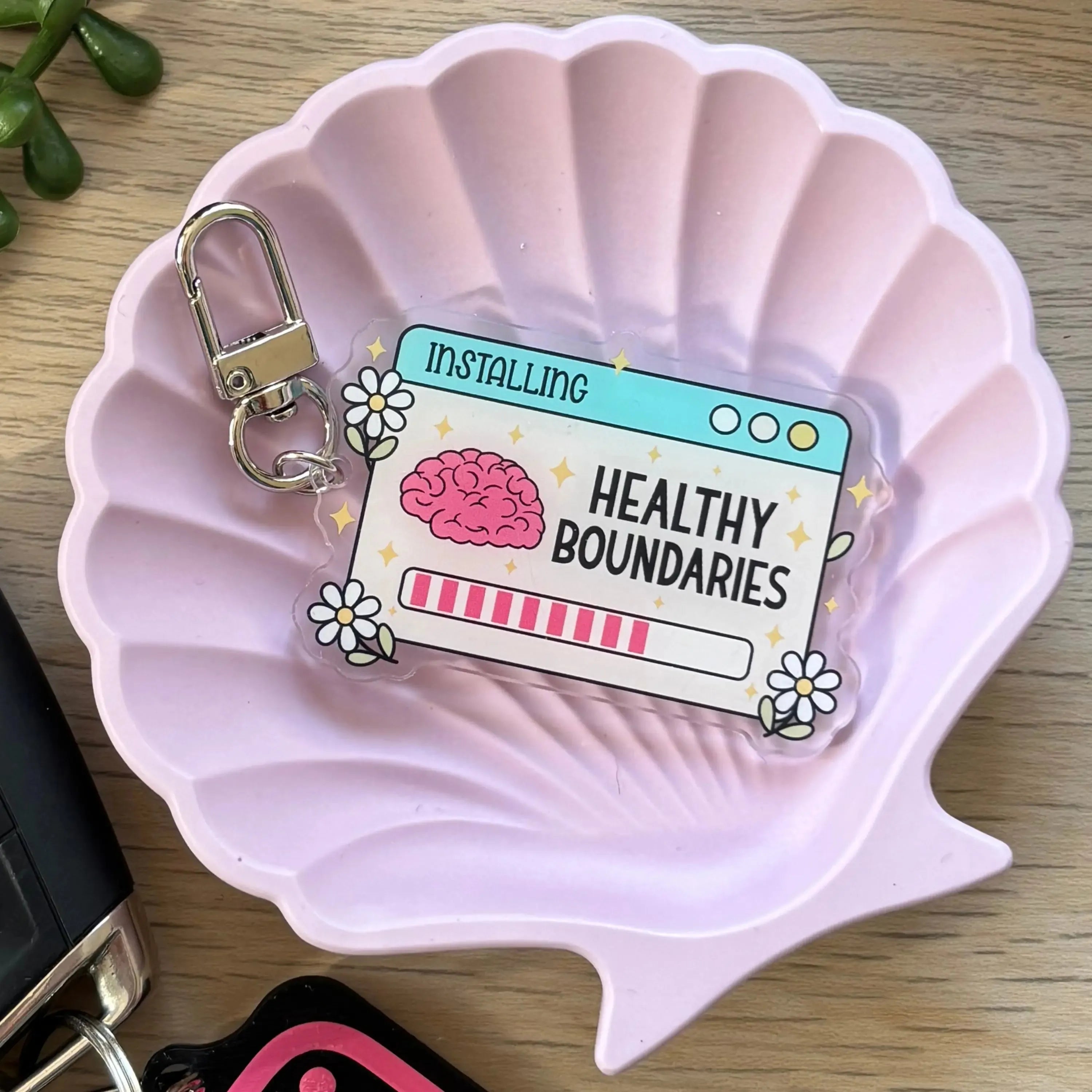 Colorful rectangular keyring with "Installing Healthy Boundaries" text, brain graphic, and progress bar design.