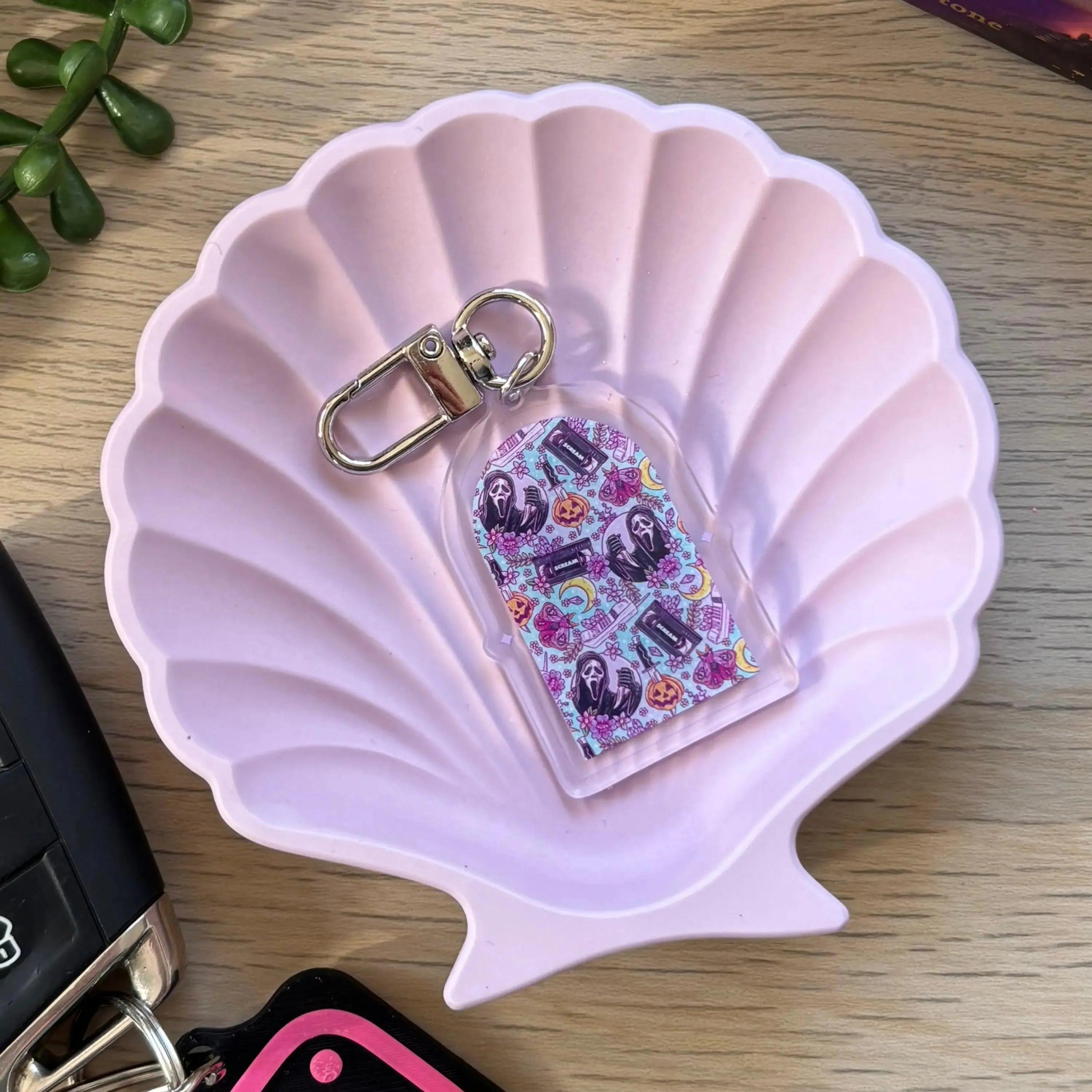Pastel-themed keyring with colorful anxious mind cartoon characters on a clear acrylic tag with silver clip.